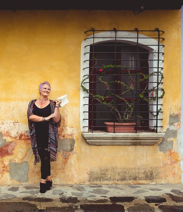 Ronda Taylor standing beside a window in Antigua, Guatemala